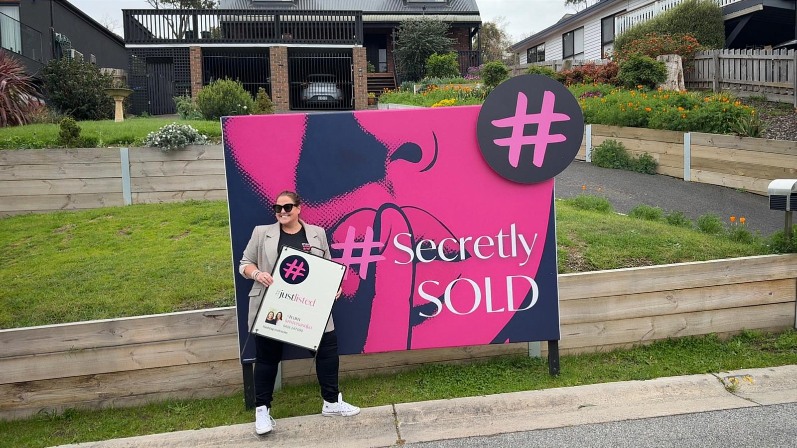 Kristen with Secret Homes signage